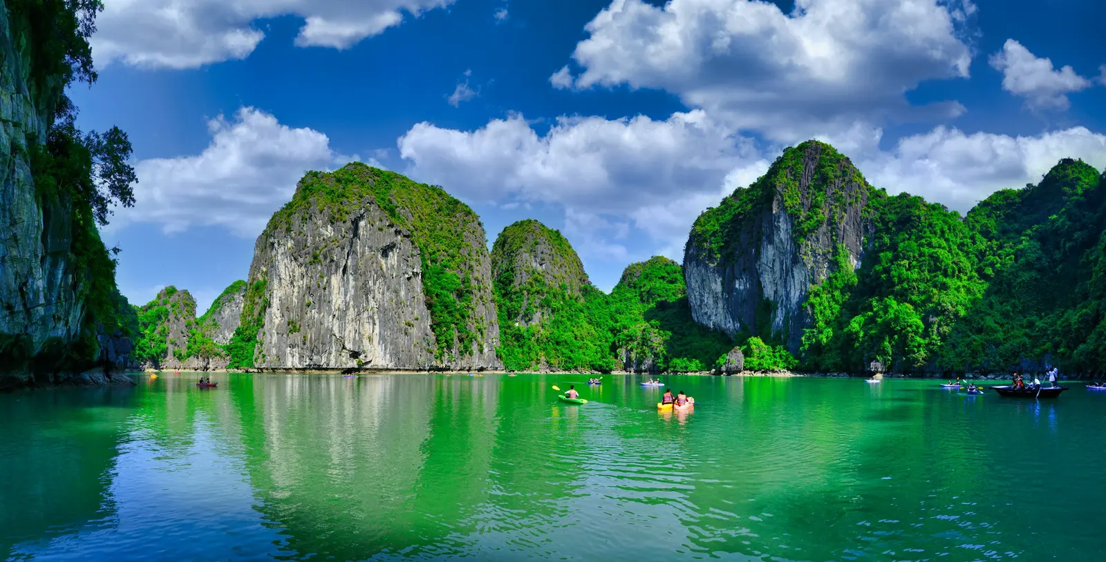 Green limestone islands rising from the waters of Ha Long Bay.